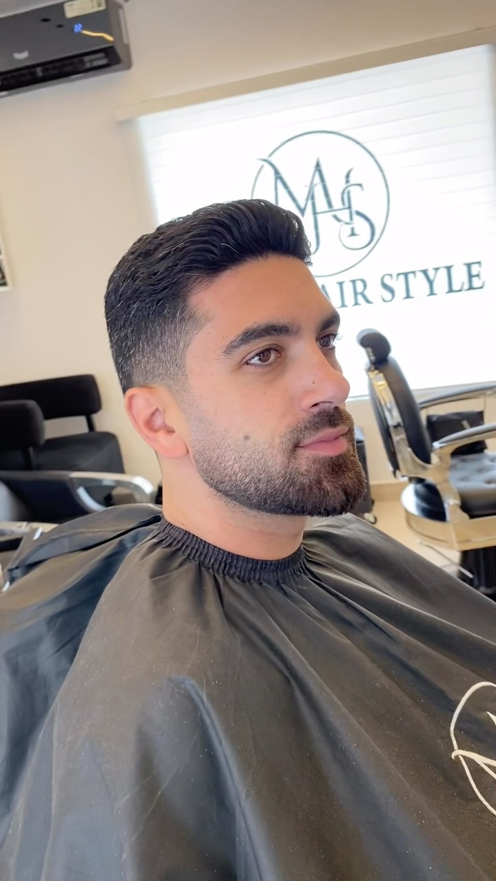A sculpted haircut and defined beard from Mimo's portfolio
