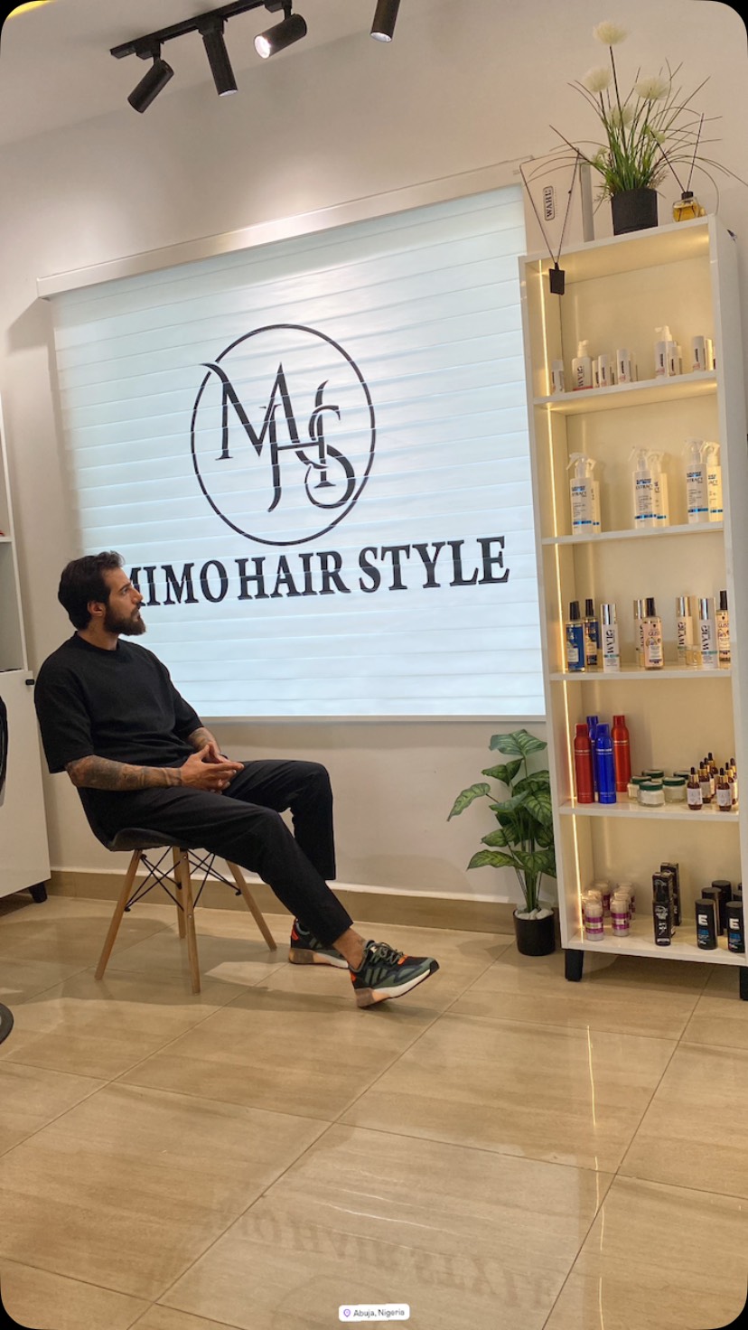Inside Mimo Hairstyle at Aminasia Center, with the studio's wall branding